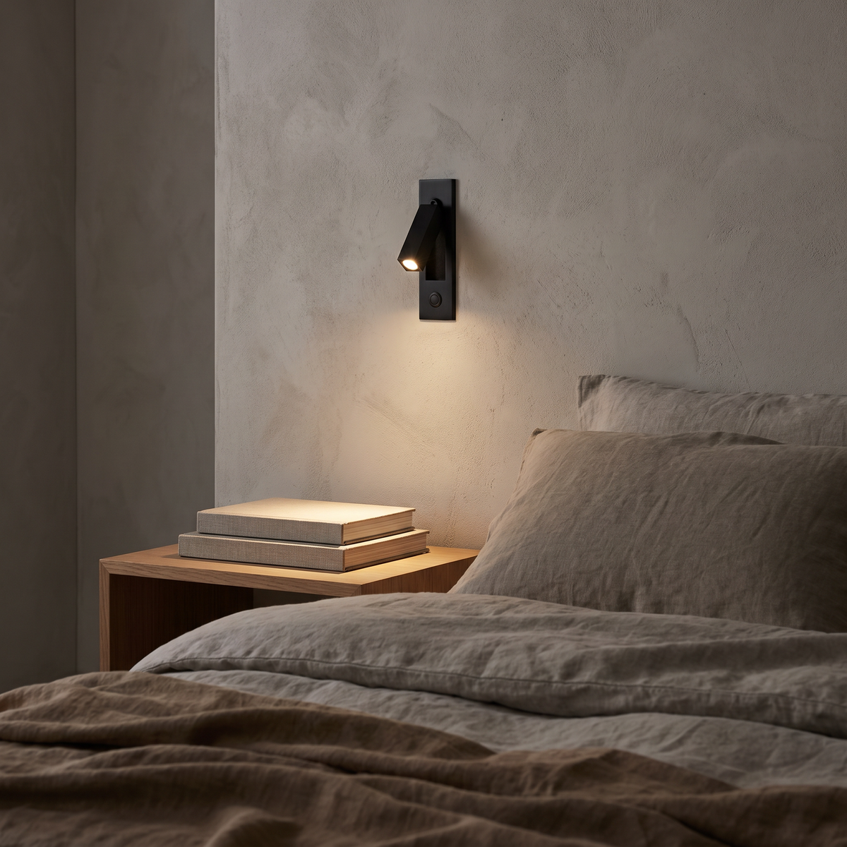 Lumo sconce above a bedside table in a neutral bedroom