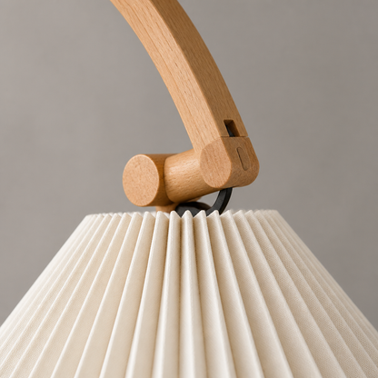 Close-up of the pleated shade and wood joint on the Caprani floor lamp